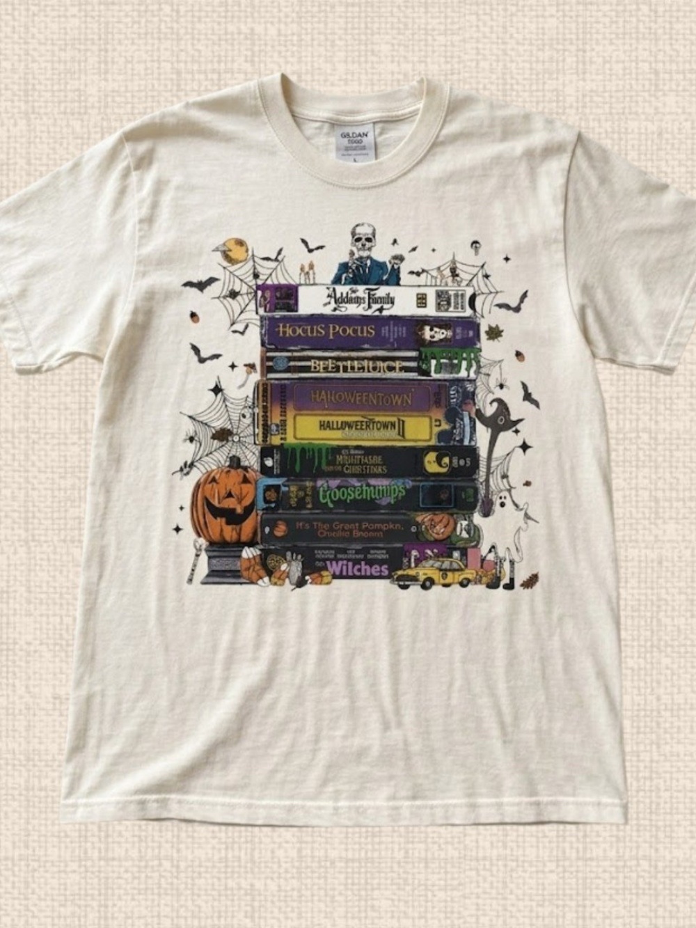 White Halloween Book Stack Graphic Tee with colorful spooky artwork